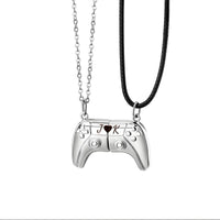 A pair of white gold game controller necklaces with engraved names